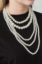 Meerlaagse parel kettingen - gedragen om de hals van een model