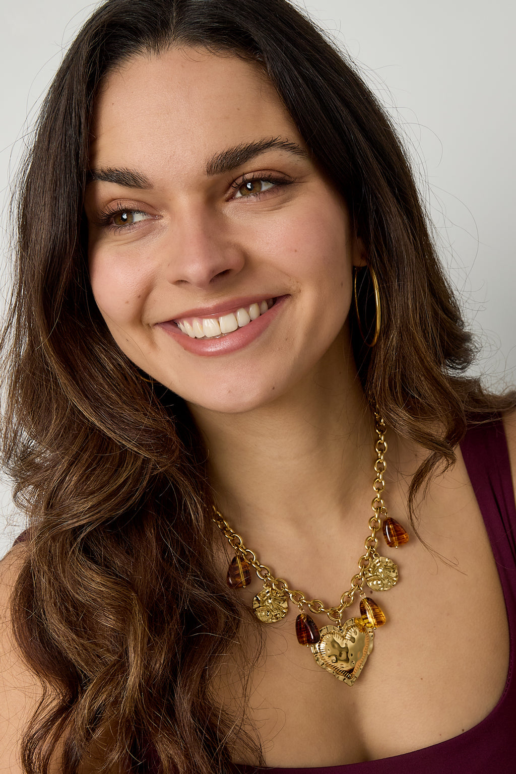 Schakelketting met hangende kralen munten en statement hart