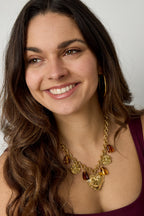 Schakelketting met hangende kralen munten en statement hart